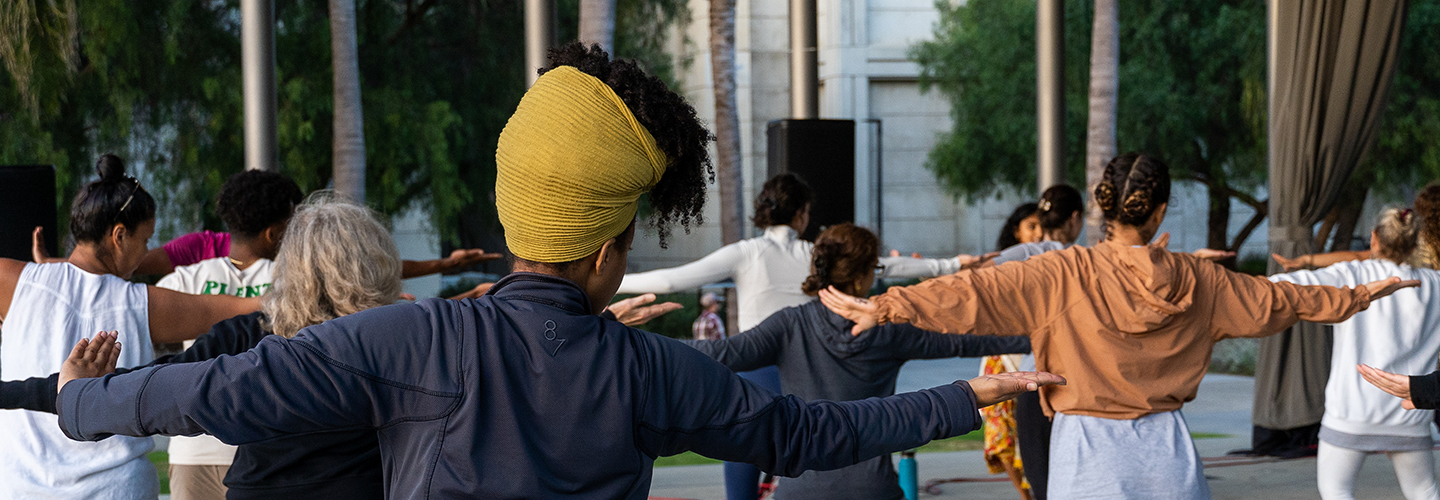 Group practicing yoga on LMU campus