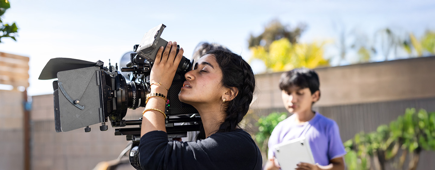 Shaili Bhambhani female student holding camera and filming on set