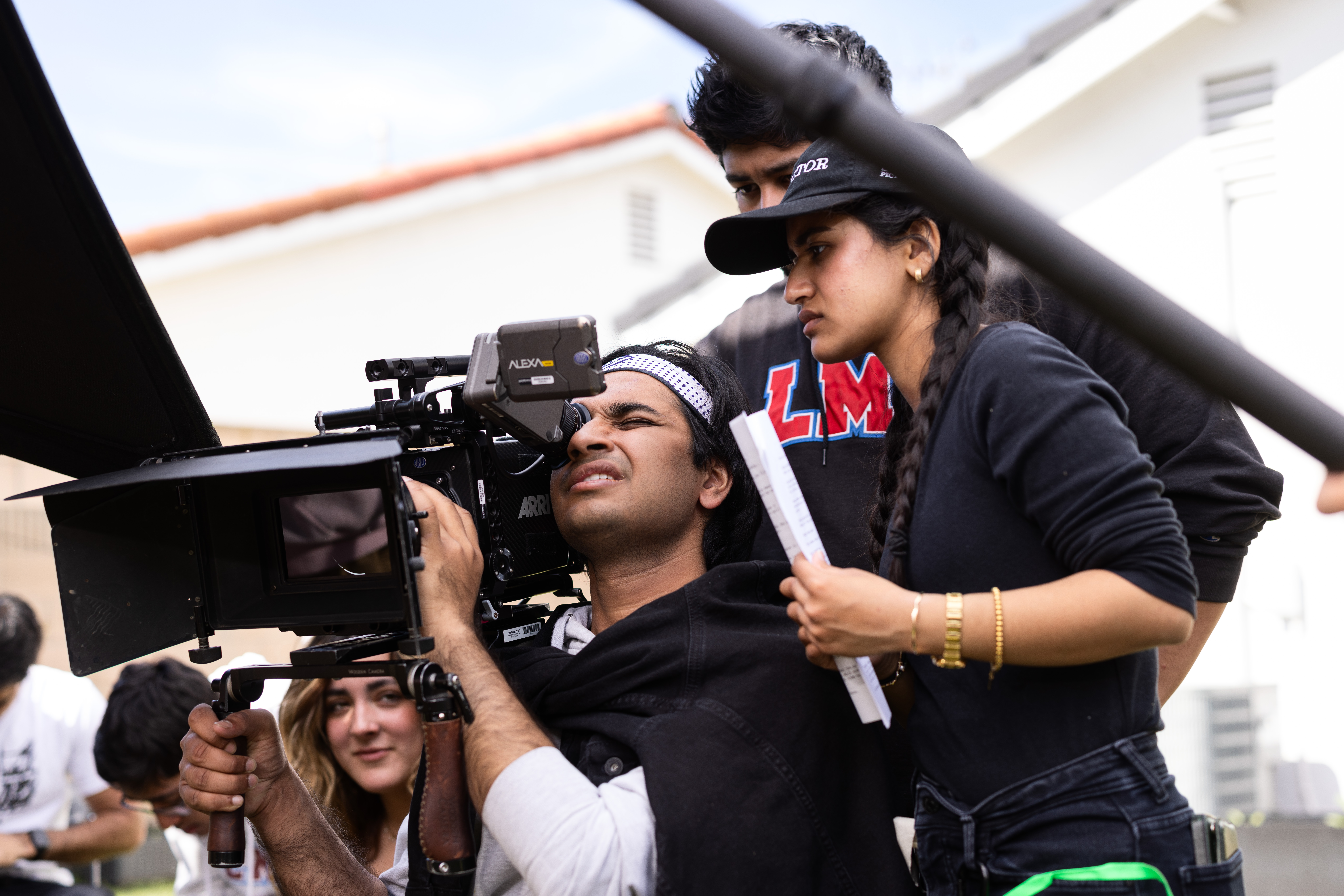 group of students filming on an outside set