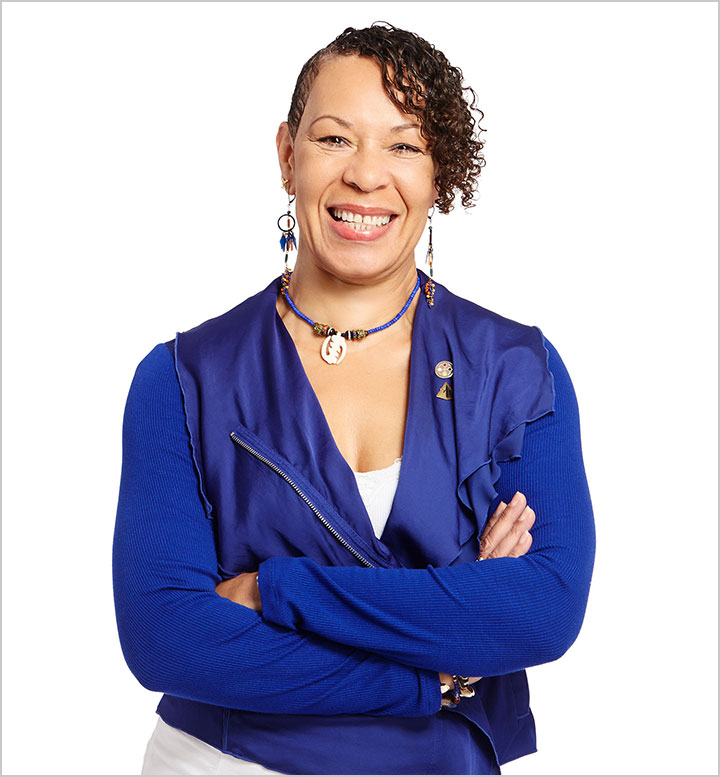 Photo of Cheryl Grills in blue jacket against white background